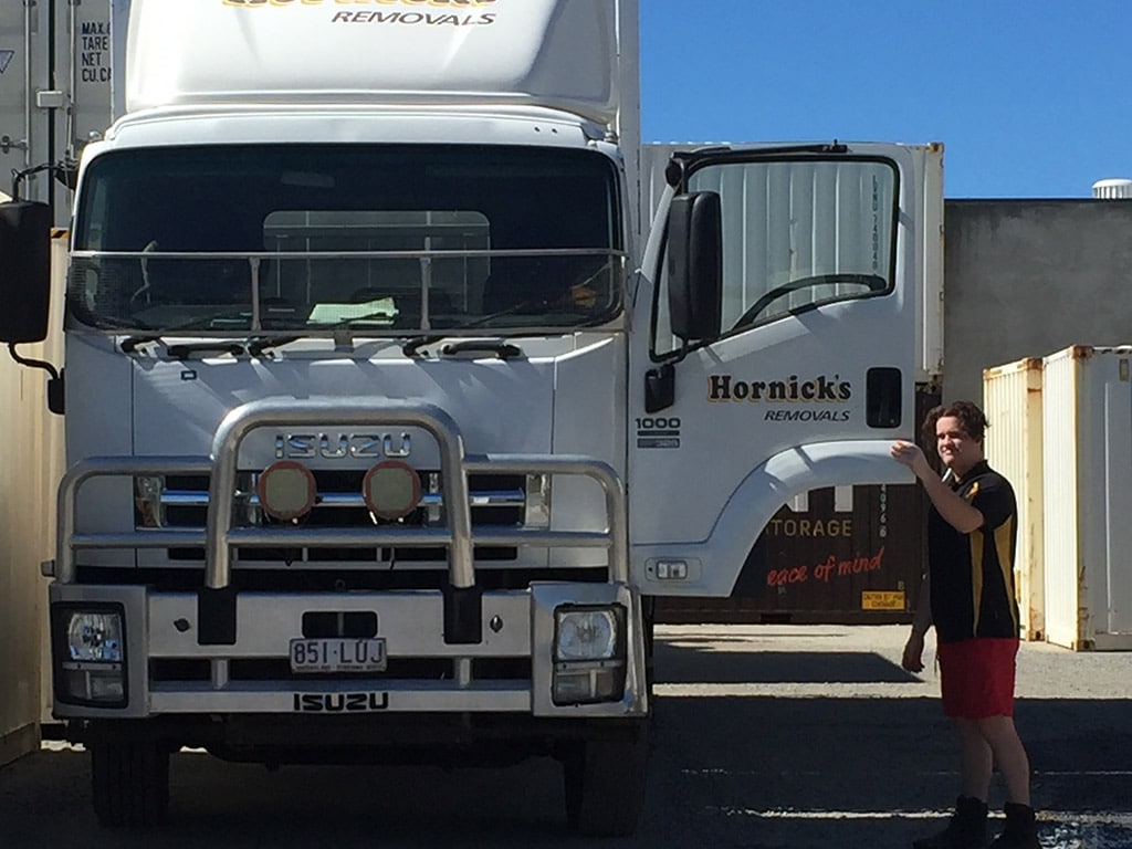 Removalist Standing by Their Truck with the Door Open - Home & Office Removals in Mackay, QLD