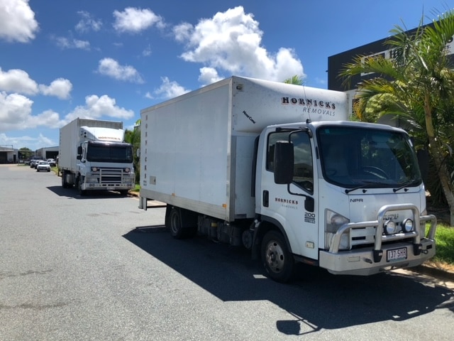 Removalist Trucks Parked in the Street on a Sunny Day - Home & Office Removals in Mackay, QLD