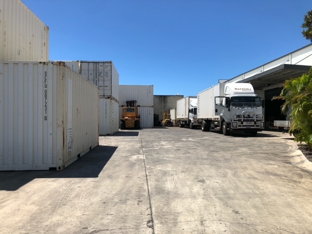 Trucks and Shipping Containers in the Parking Lot - Home & Office Removals in Mackay, QLD
